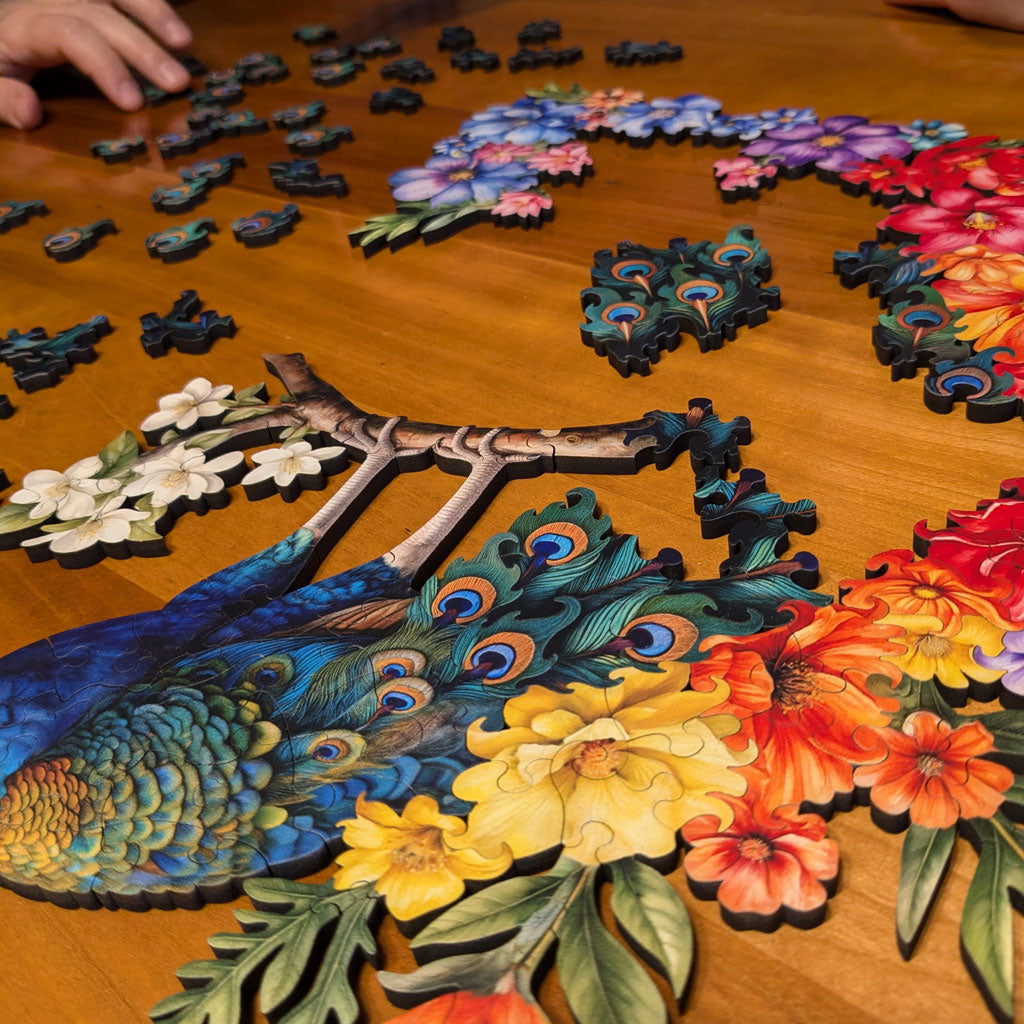 Fathom Puzzles Bloomin' Plumage Wooden Laser Cut Jigsaw 200 Pieces Geoff Cota Peacock pieces spread out on table
