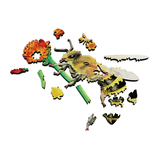 Partially assembled wooden bee puzzle with several colorful pieces spread out, revealing the laser-cut edges and unique piece shapes