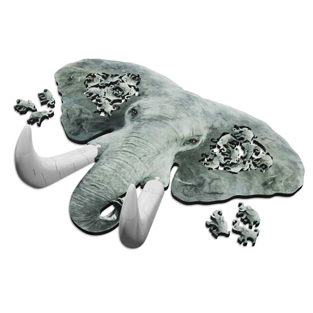 Angled view of the elephant jigsaw puzzle lying flat, showing removable tusk sections and clusters of elephant-shaped pieces near the ears.