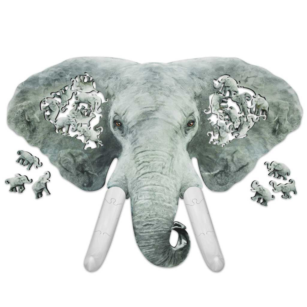 Overhead view of an elephant-shaped wooden jigsaw puzzle, with family-shaped elephant cutouts in each ear and loose elephant pieces around the edges.